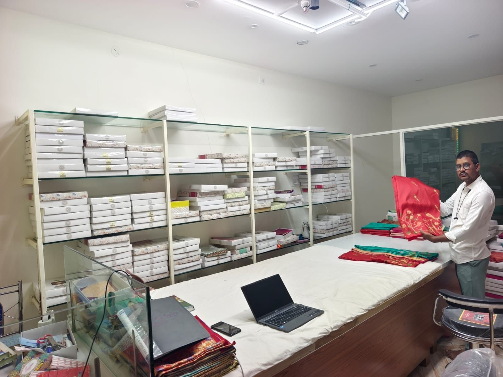 Silk sarees being sorted and checked at the Ramanji Handlooms counter