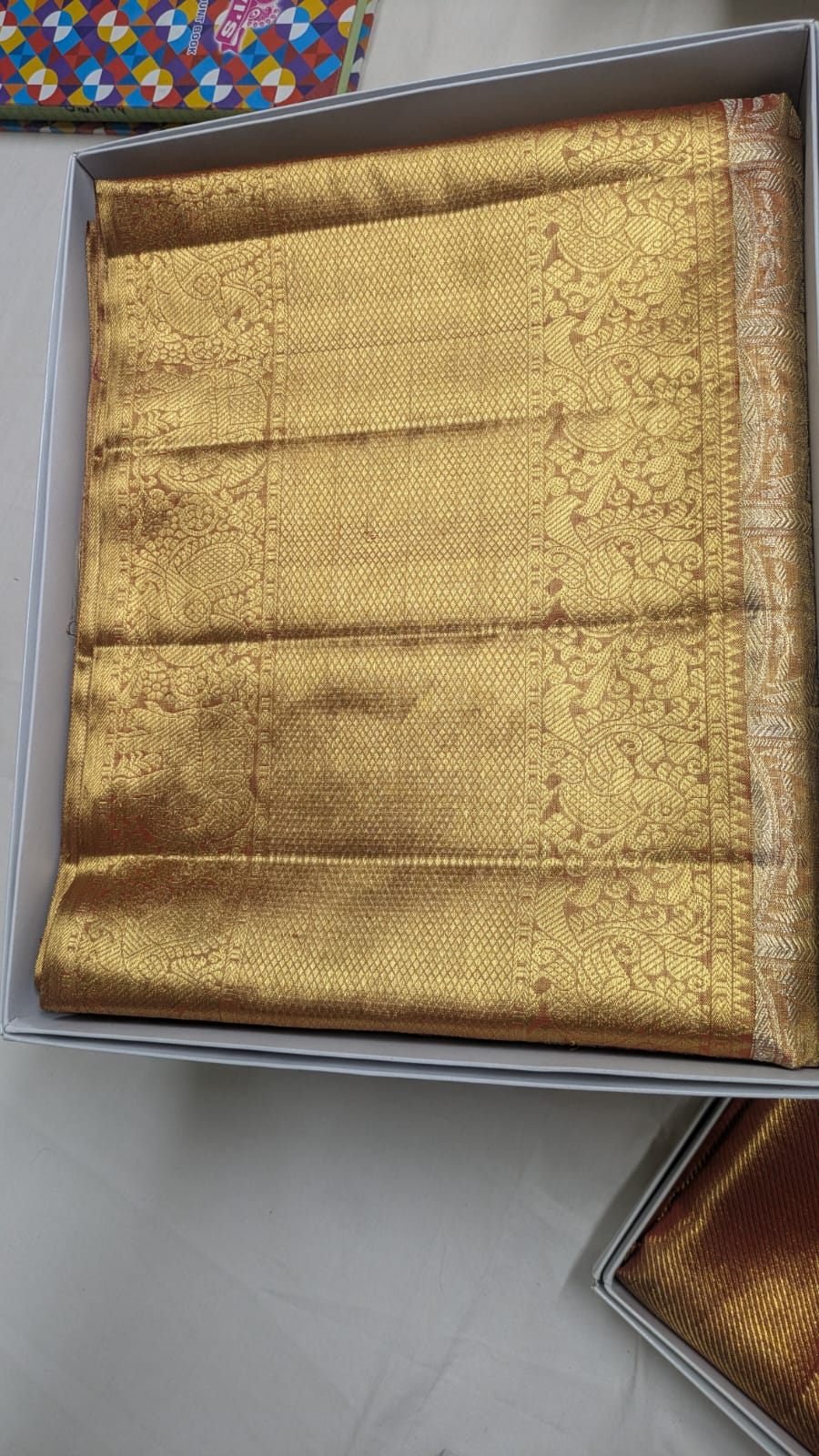All-gold diamond lattice pattern handloom silk saree with peacock motif border, Ramanji Handlooms Dharmavaram stock