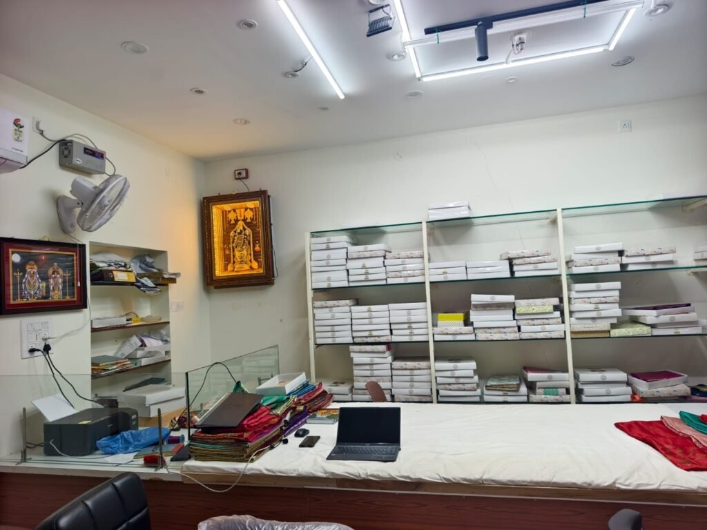 Ramanji Handlooms Dharmavaram showroom with saree boxes on glass shelves