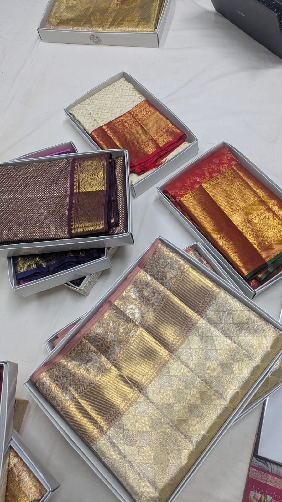Distinctive silver and gold checkered pattern handloom silk saree with other sarees, Ramanji Handlooms Dharmavaram stock