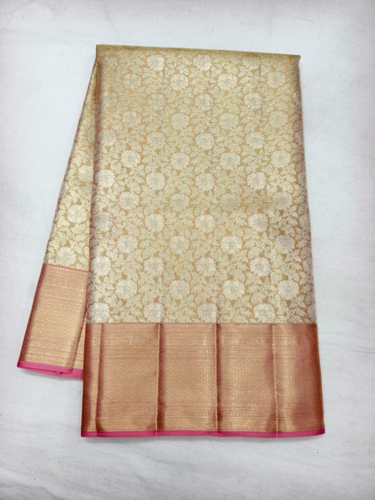 Cream Dharmavaram silk saree with gold floral jaal brocade and a broad peach gold zari border