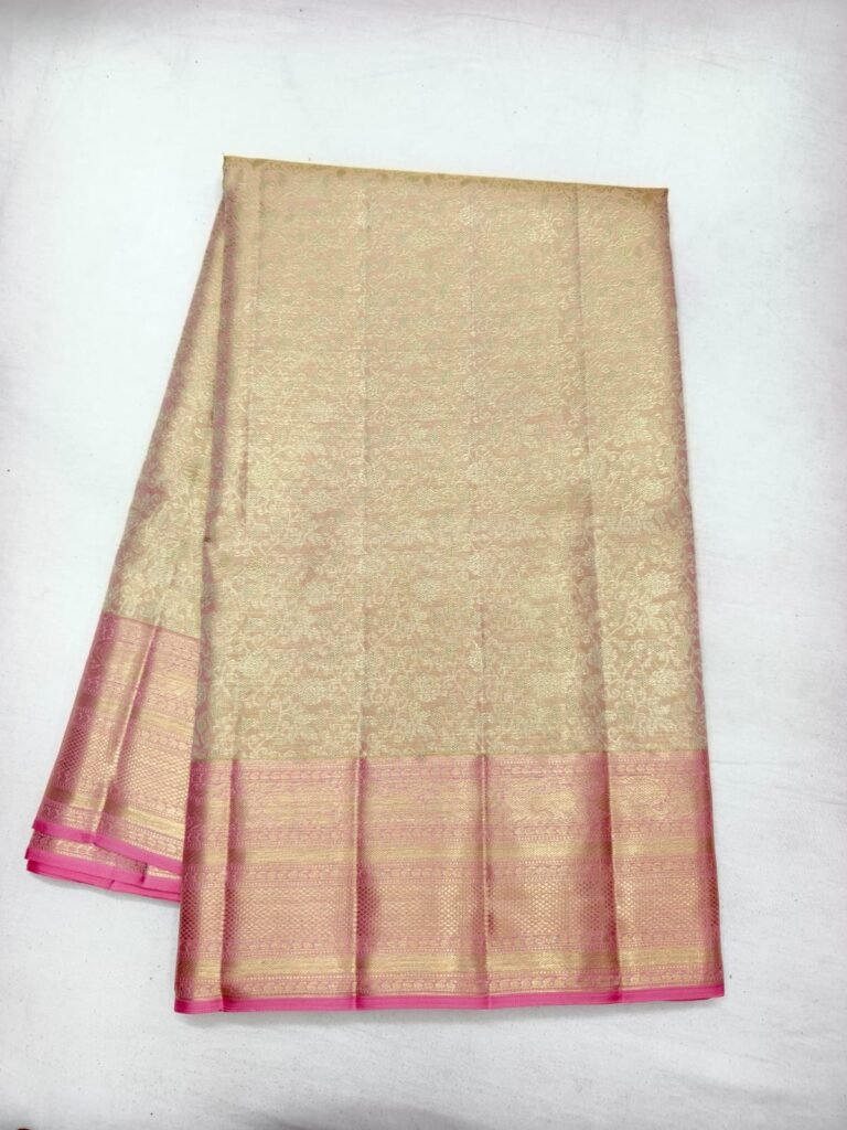 Cream gold Dharmavaram silk saree with floral brocade and a broad pink gold zari border