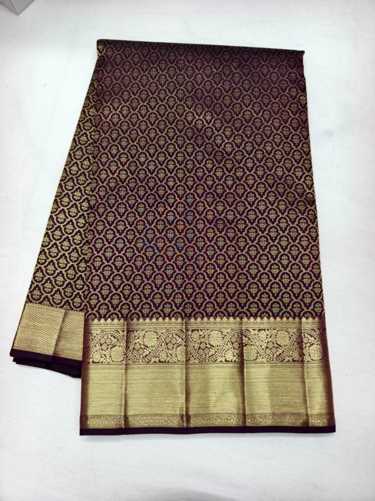 Dark maroon Dharmavaram butta saree with dense gold butta jaal and a broad gold zari peacock border
