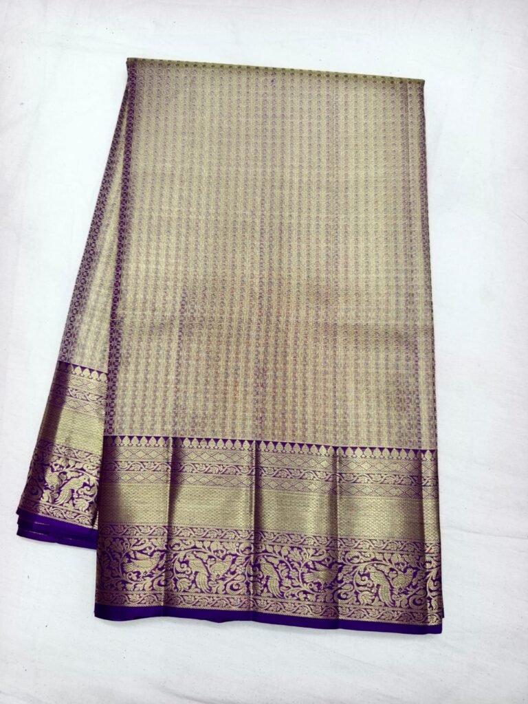 Gold Dharmavaram pattu saree with fine stripe and dot brocade and a broad purple gold zari border