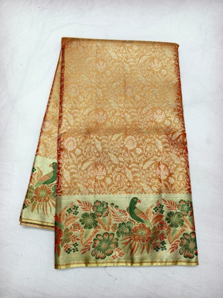 Peach gold Dharmavaram meenakari saree with floral brocade and a green and orange peacock border