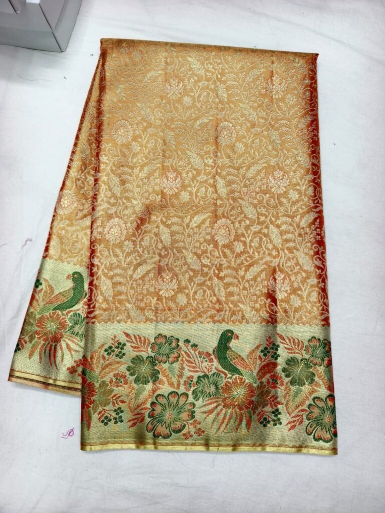 Peach Dharmavaram meenakari saree with gold floral brocade and a green and orange peacock meenakari border