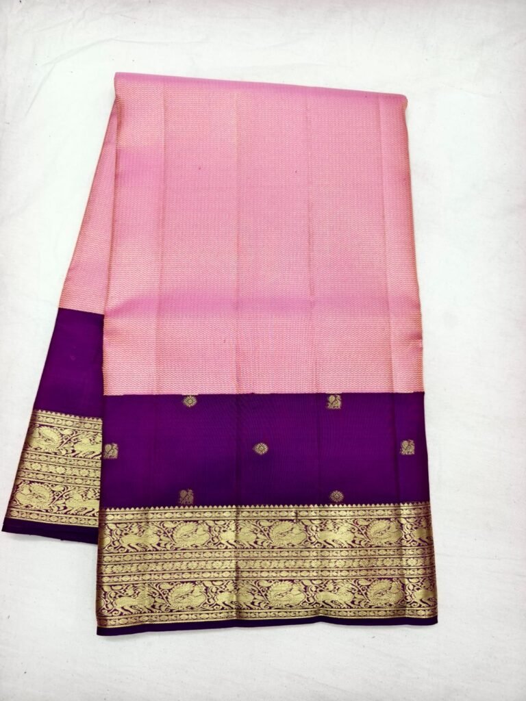 Pink Dharmavaram handloom pattu saree with a purple contrast pallu and a broad gold zari peacock border
