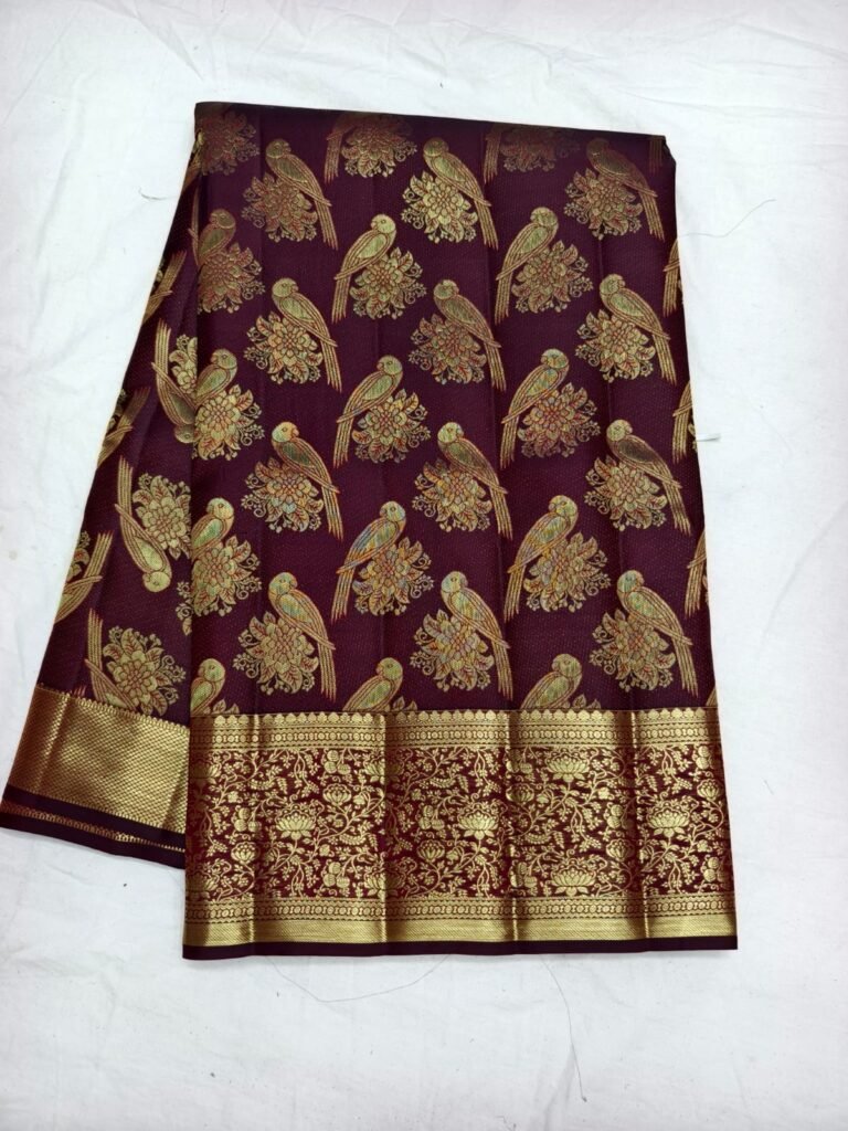 Wine Dharmavaram parrot design saree with large gold parrot and floral motifs and a broad zari border
