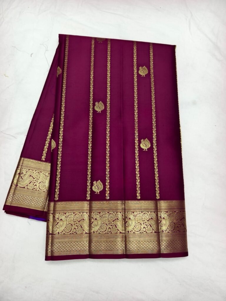 Wine purple Dharmavaram butta saree with gold mango butta, zari stripes and a broad peacock border